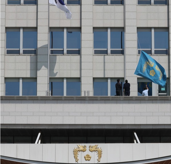 헌법재판소가 윤석열 대통령 파면을 선고한 4일 서울 용산구 대통령실에서 관계자들이 봉황기를 내리고 있다. 대통령실통신사진기자단