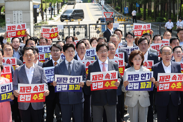 국민의힘 김용태 비상대책위원장과 권성동 원내대표가 11일 이재명 대통령의 공직선거법 위반 사건의 파기환송심을 사실상 무기한 연기한 서울고등법원 앞에서 열린 현장 의원총회에서 구호를 외치고 있다. 연합뉴스