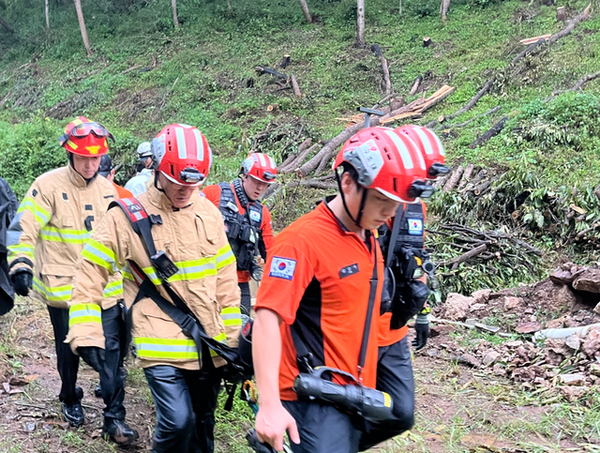 17일 경북 의성군 안평면 석탑리 임야에서 벌목사고가 발생하자 소방대원들이 산악용 들것을 이용한 구조작업을 마친 뒤 장비를 정리하며 현장을 이동하고 있다. 의성소방서 제공